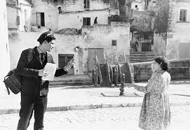 Historical photo by Mario Carbone of a postman in the Sassi of Matera, 1950s, featured on Matera Private Tours